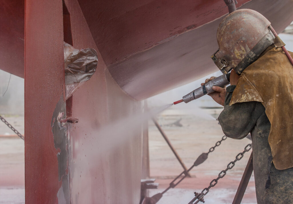 worker sandblasting the corroded hull of a boat 2025 02 06 04 03 59 utc